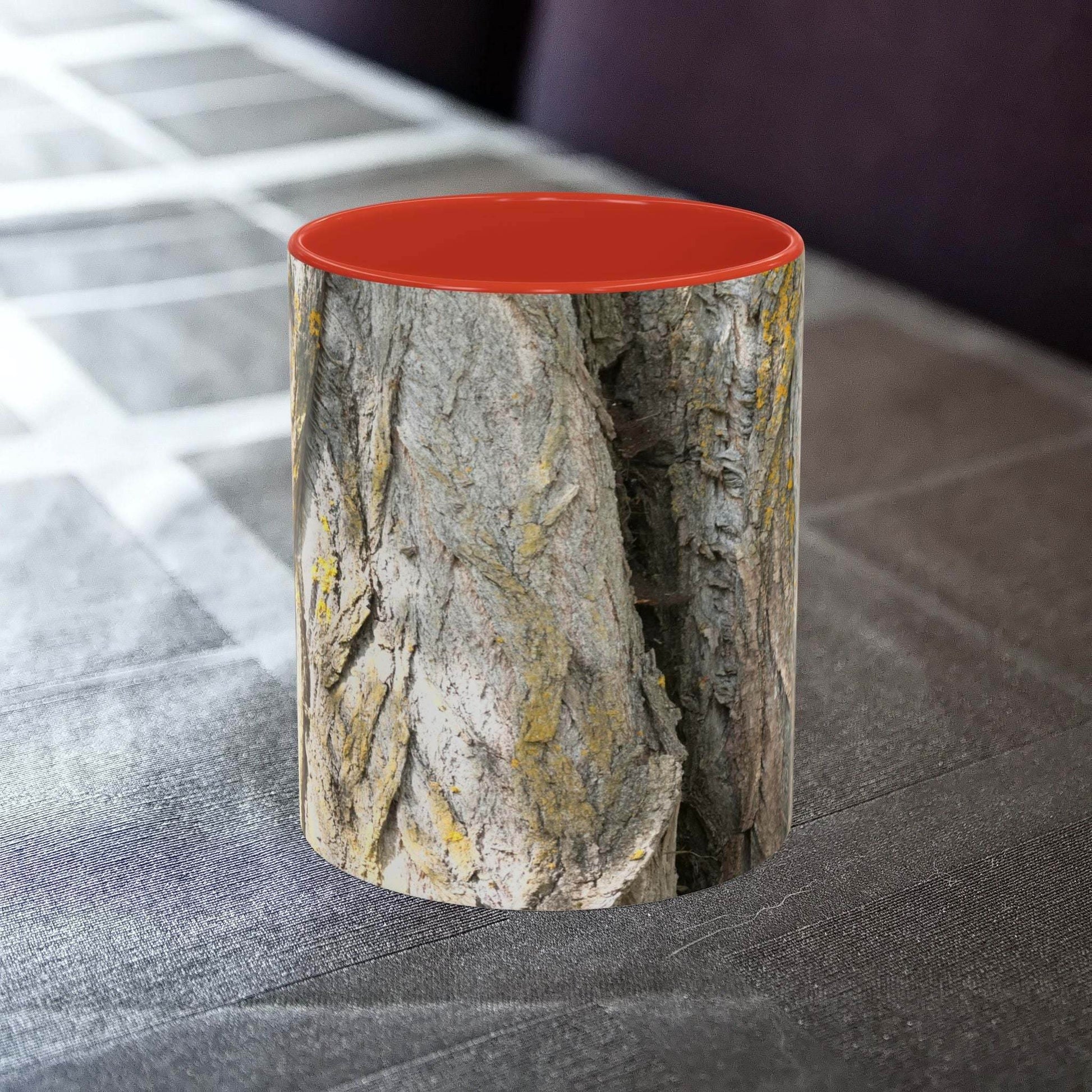 Coffee mug with tree trunk design on a table.