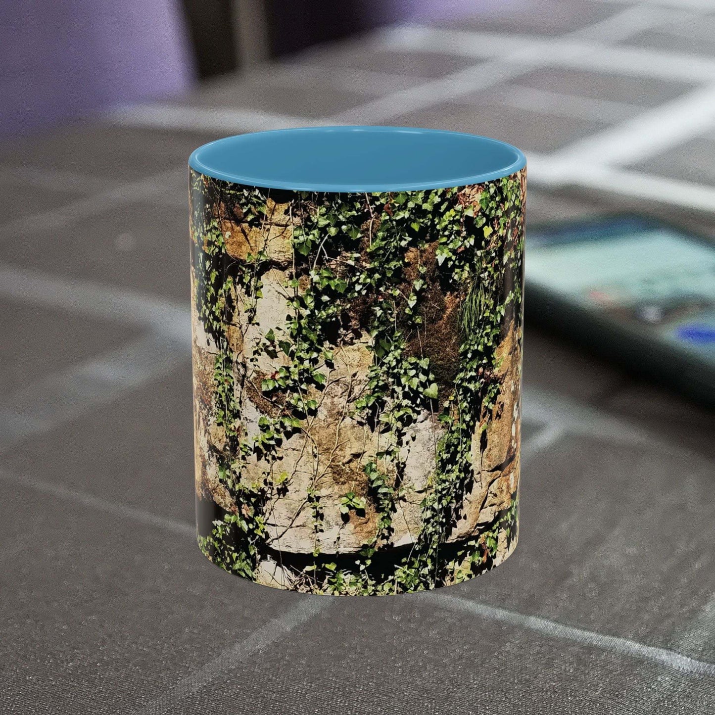 Overgrown rocks adventure mug with nature-inspired design on table.