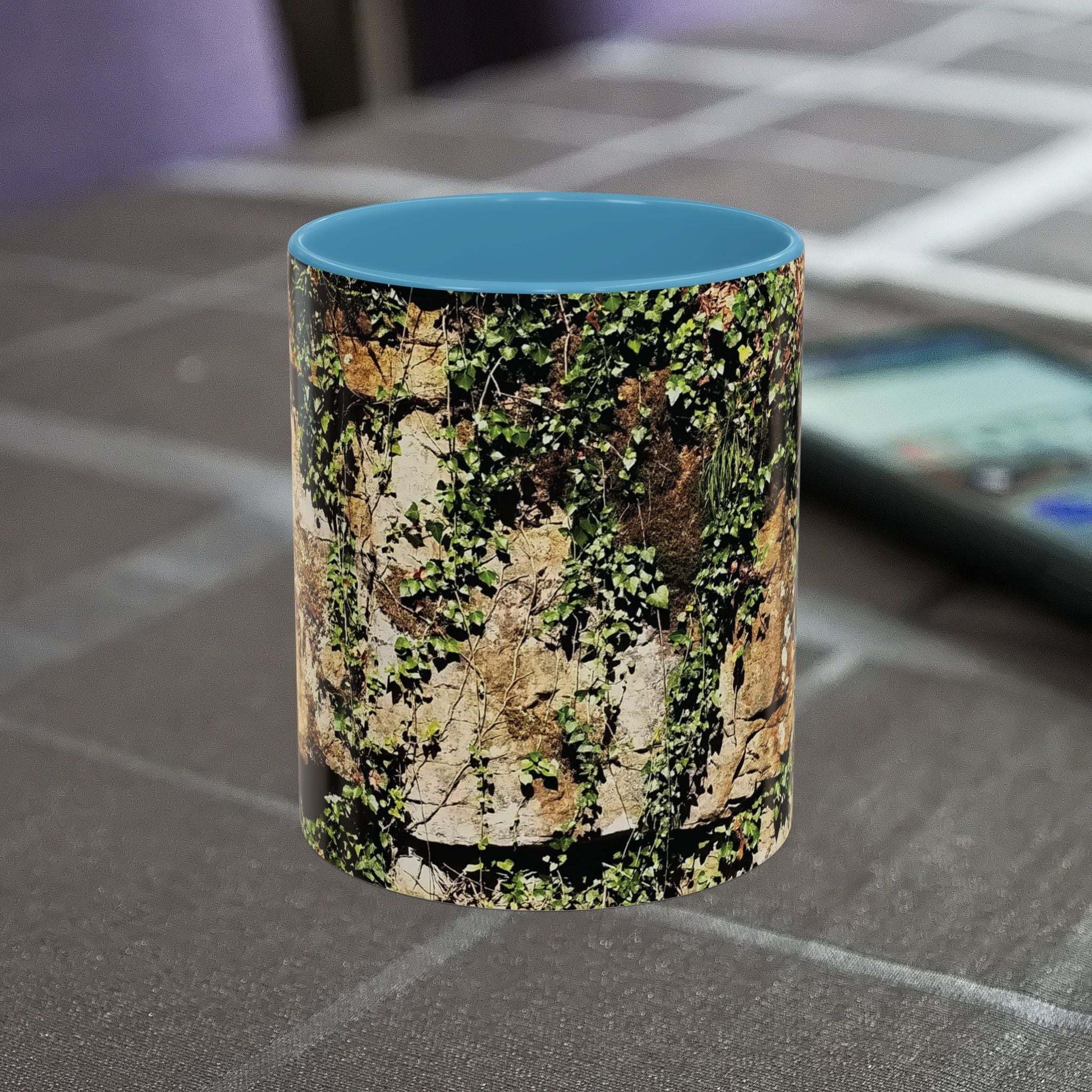 Overgrown rocks adventure mug with nature-inspired design on table.
