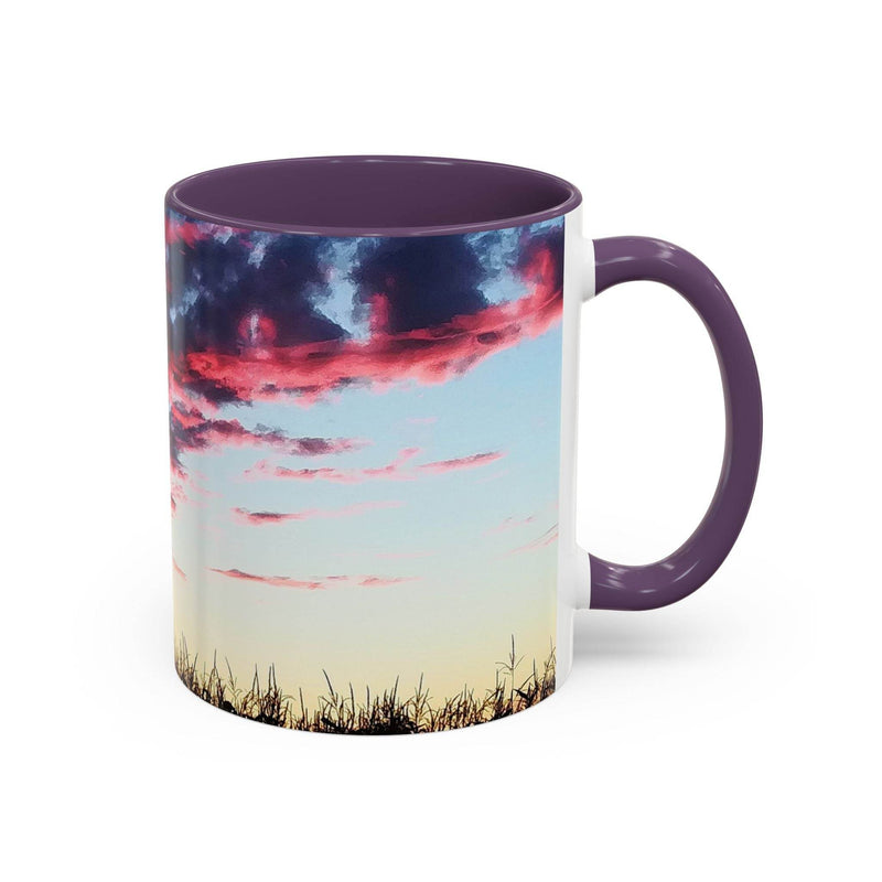 Premium 11oz nature inspired Sunset Accent Coffee Mug showing its purple handle and purple inside near a lamp.