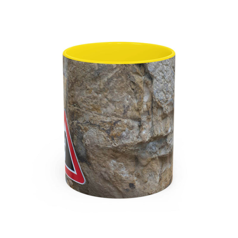Rugged 11oz Rocky Mug, Mountain Lovers, Danger of Falling Rocks showing the yellow handle and yellow inside next to a bowl.