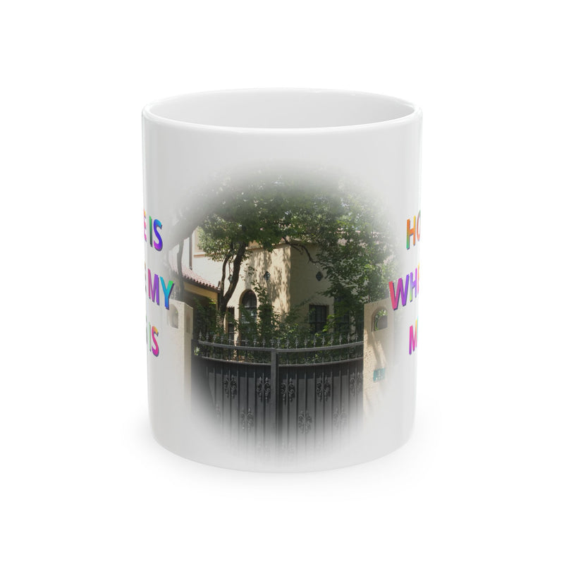 Cheerful 11oz Home Is Where My Mug Is | Ceramic Coffee Mug standing right next to green botanical indoor plants.