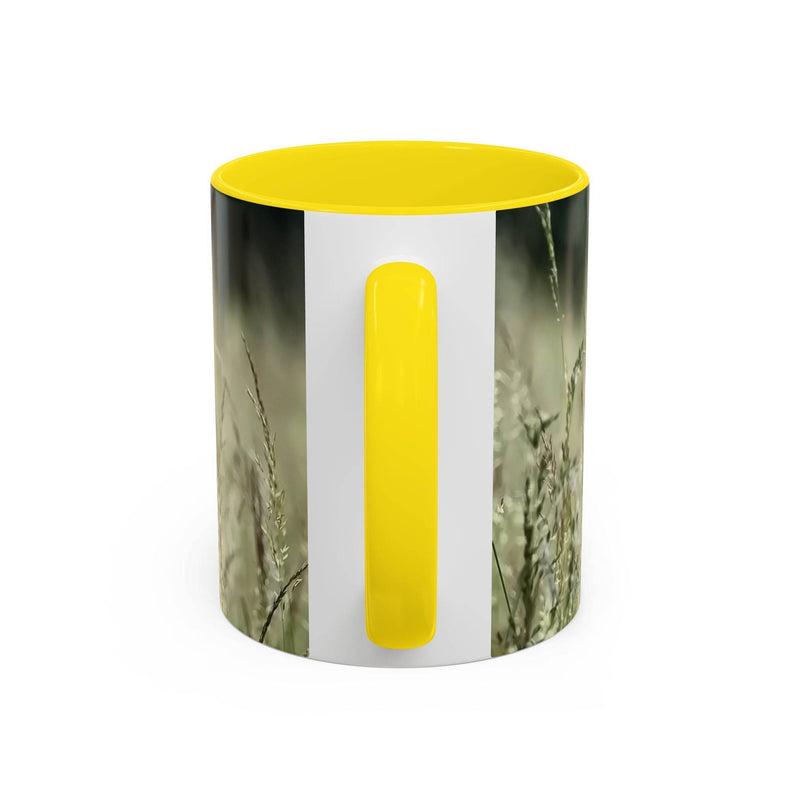 Premium 11oz Mug, Flowering Grass - Bring Nature Inside on a tray, featuring a yellow handle and inside.