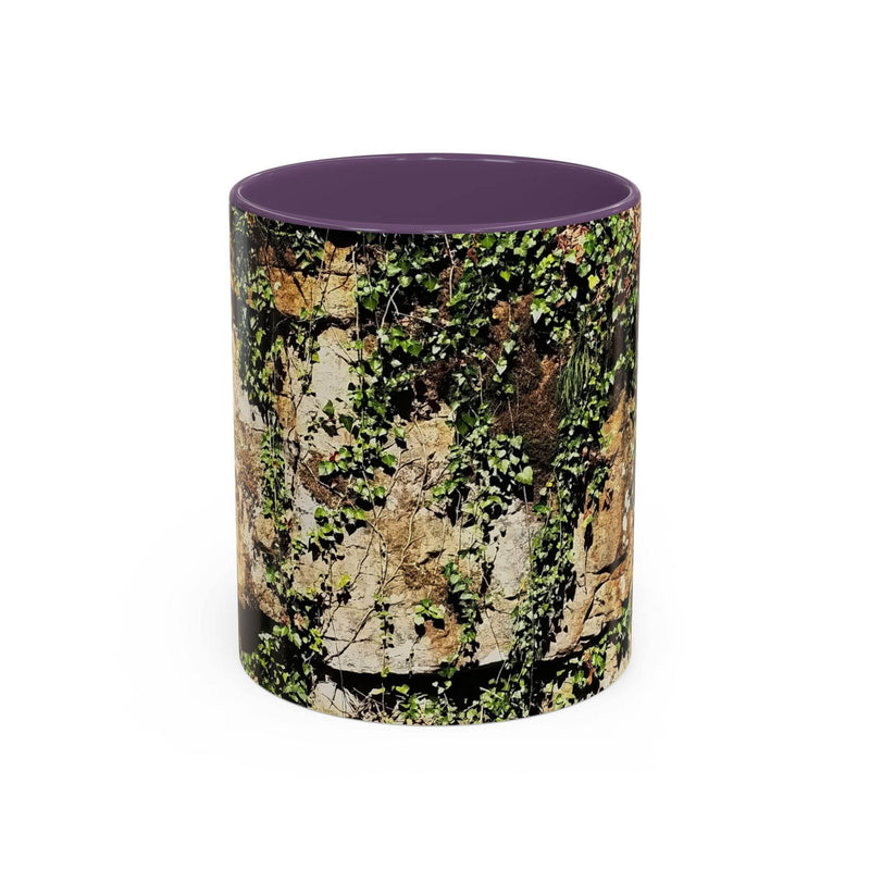 Adventurous 11oz Mug - Overgrown Rocks Adventure Coffee Mug showing the purple handle and purple inside near a lamp.