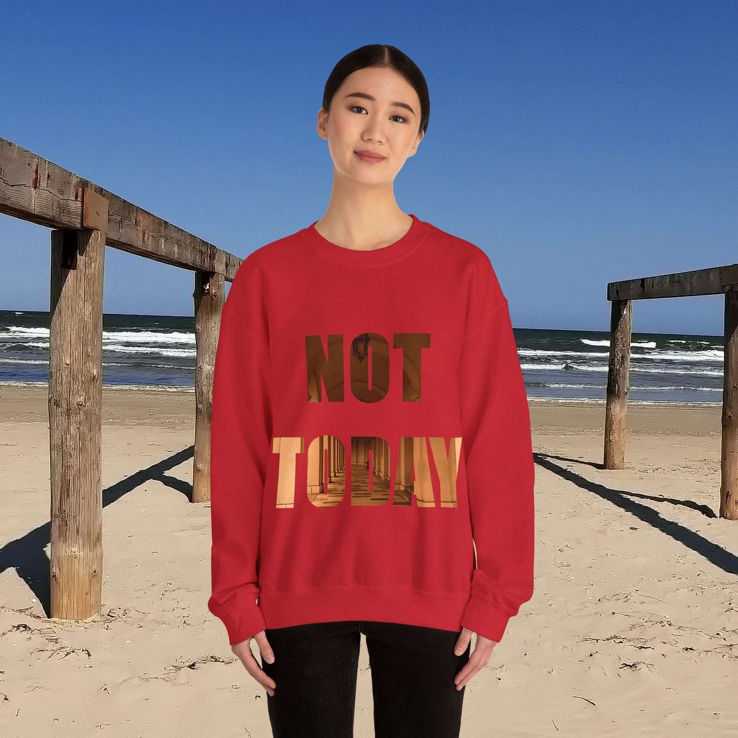 Cozy Unisex Crewneck Sweatshirt in red with "Not today, maybe tomorrow" text on a beach background.