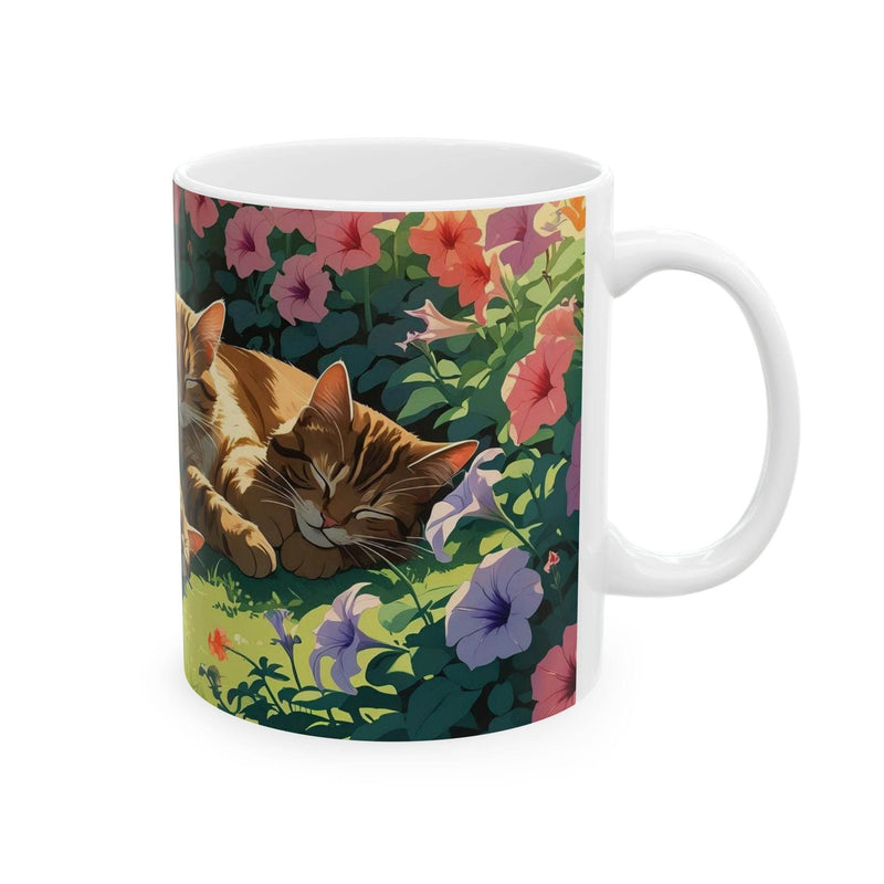 Charming 11oz ceramic Coffee Mugs - Sleeping Cats in the Garden Design on a rustic wooden patio table.