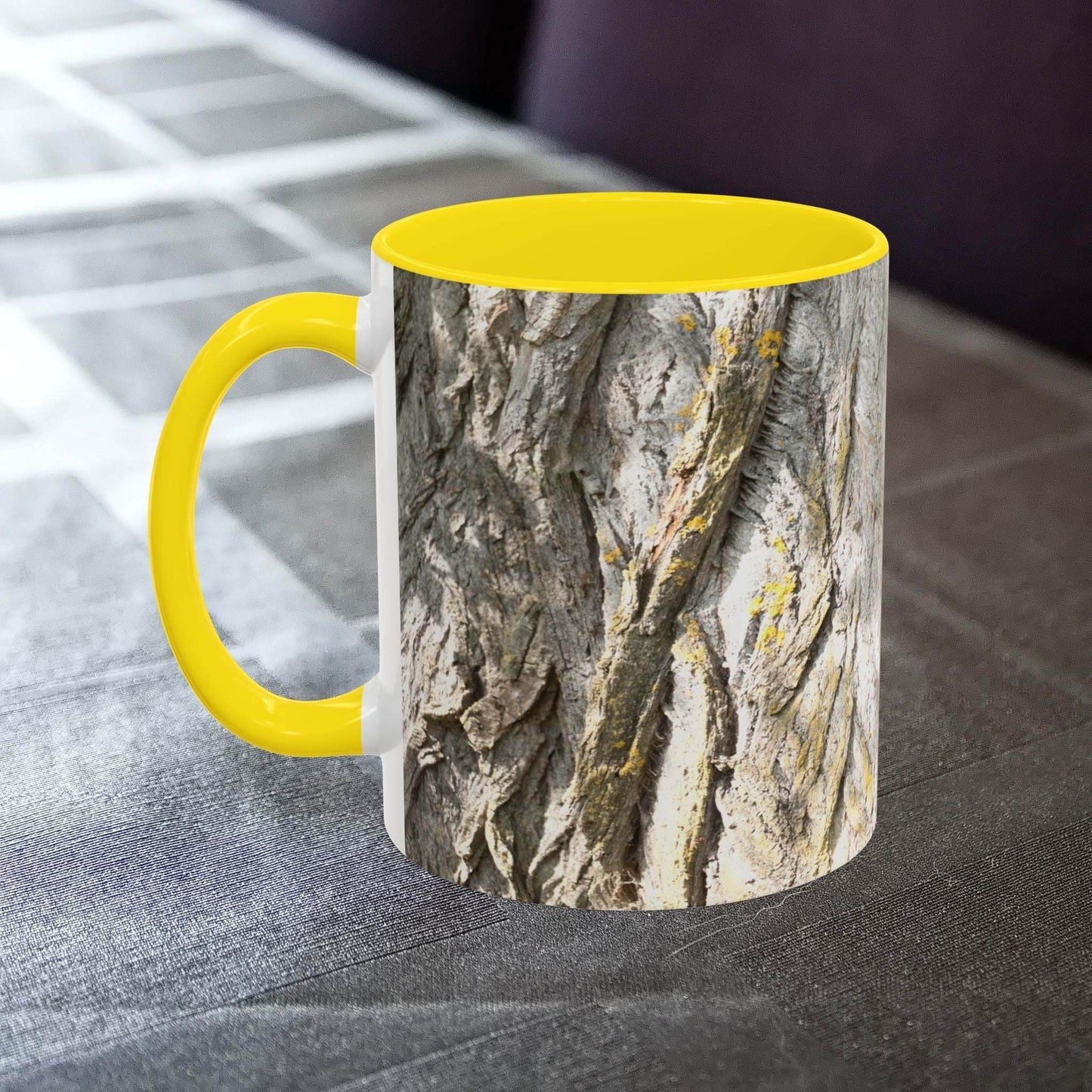 Coffee mug with tree trunk design and yellow interior, ideal for nature lovers.