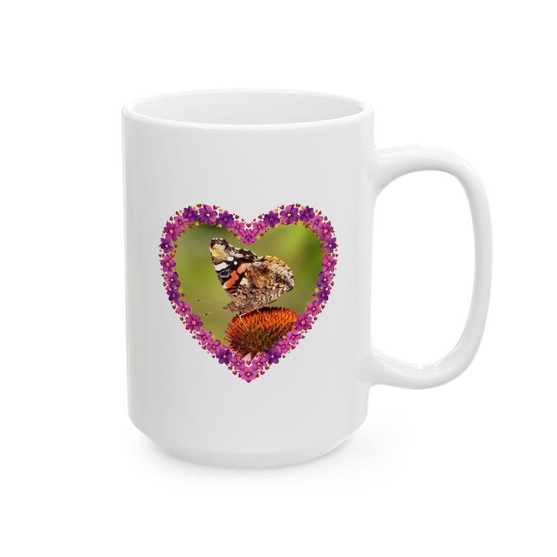 Sturdy 15oz Heart Flower Frame Butterfly Ceramic Mug displaying vibrant garden colors next to home decor items.