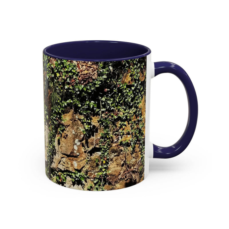 Premium 11oz Mug - Overgrown Rocks Adventure Coffee Mug on a table, featuring a navy handle and navy inside.