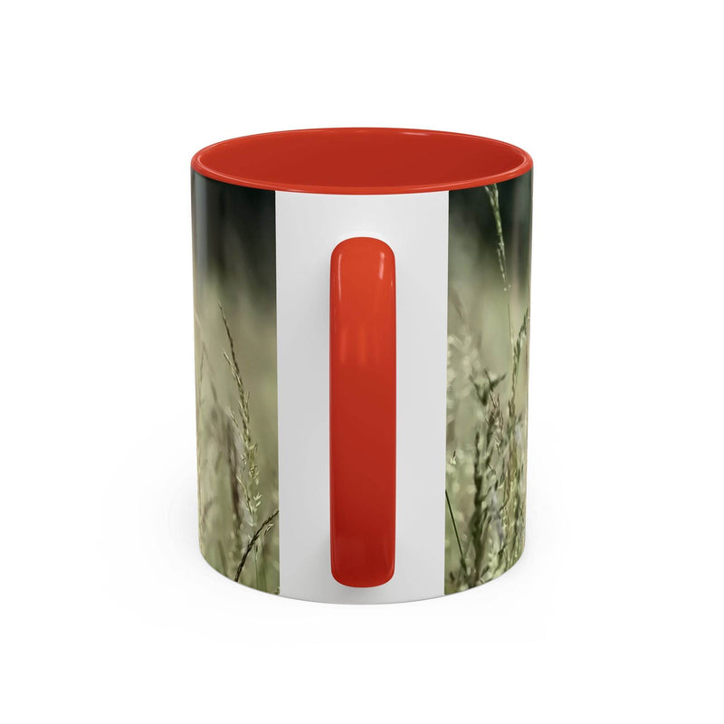 Premium 11oz Mug, Flowering Grass - Bring Nature Inside on a shelf, featuring a red handle and red inside.