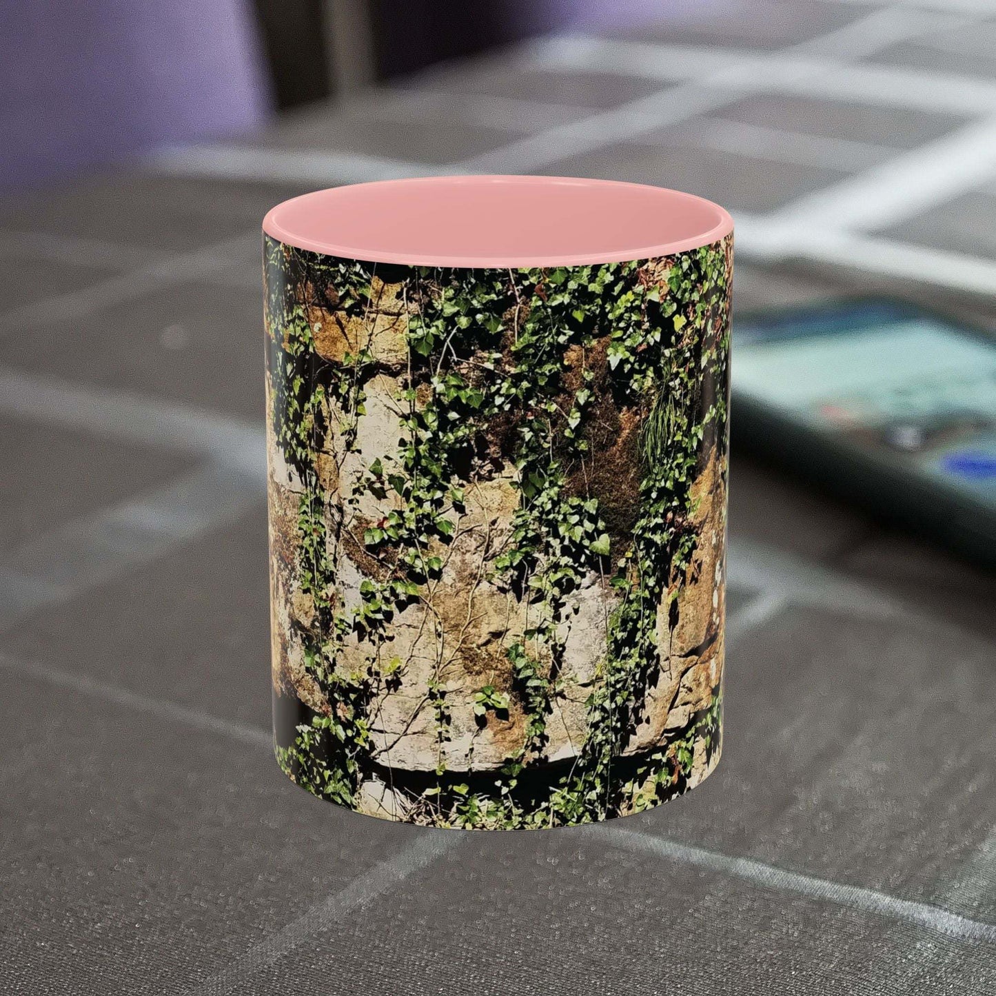 Overgrown Rocks Adventure Mug with nature design on table.