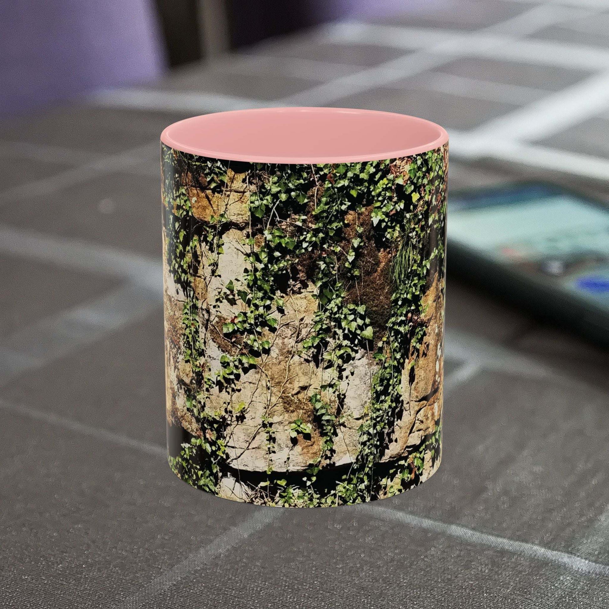 Overgrown Rocks Adventure Mug with nature design on table.