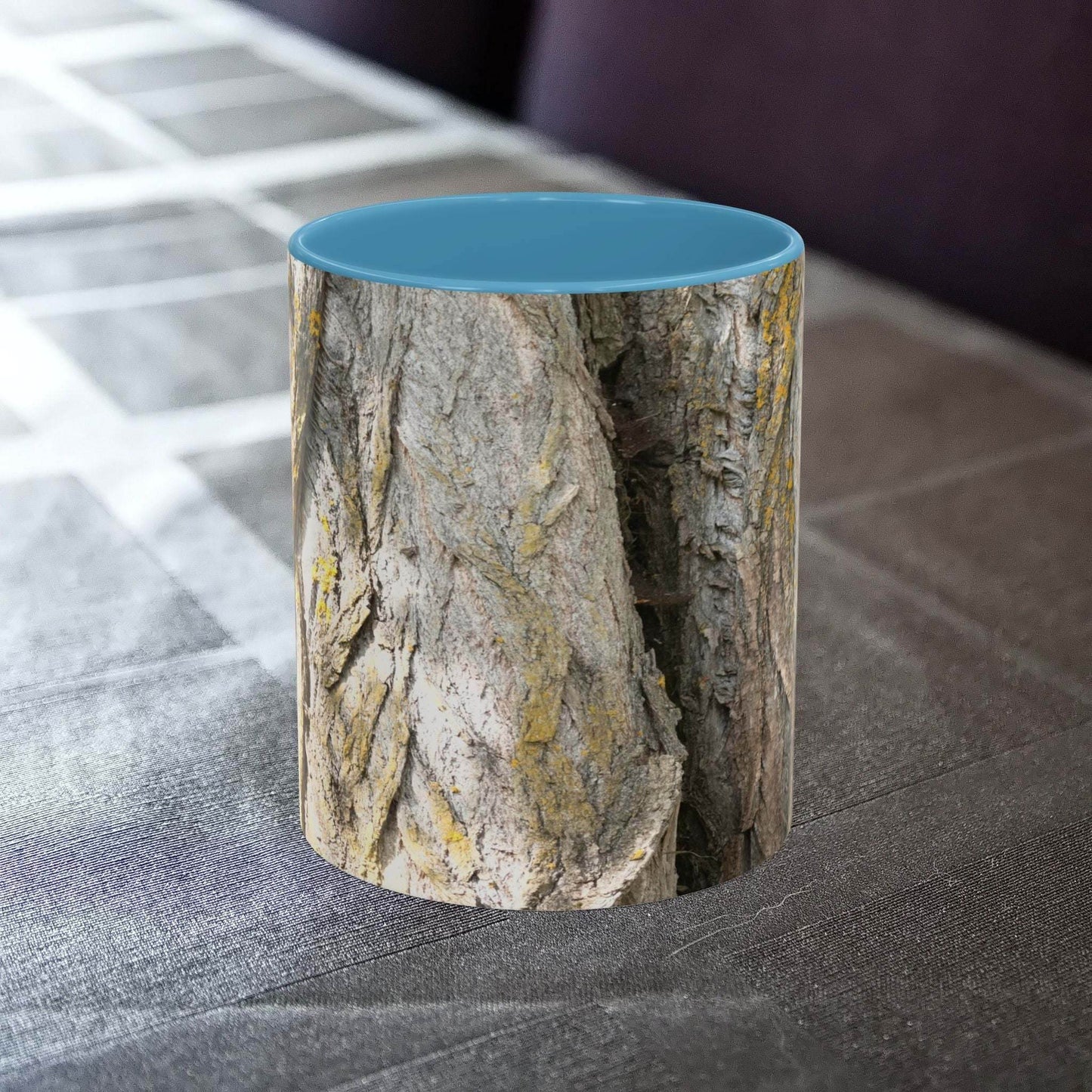 Rustic tree trunk design coffee mug on a table.
