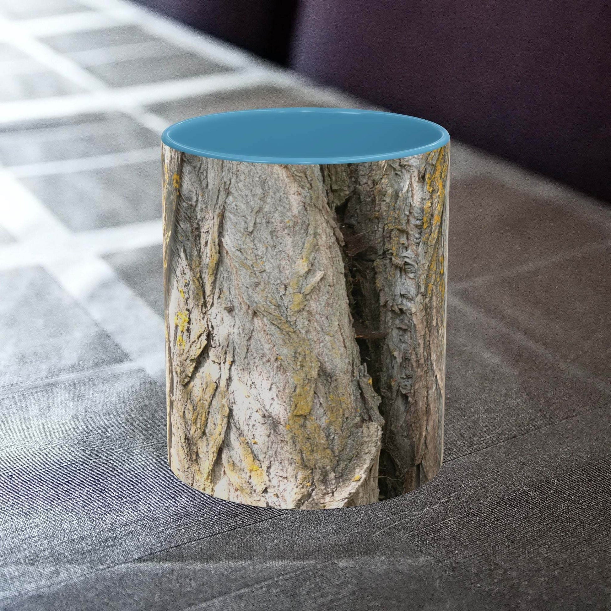 Rustic tree trunk design coffee mug on a table.