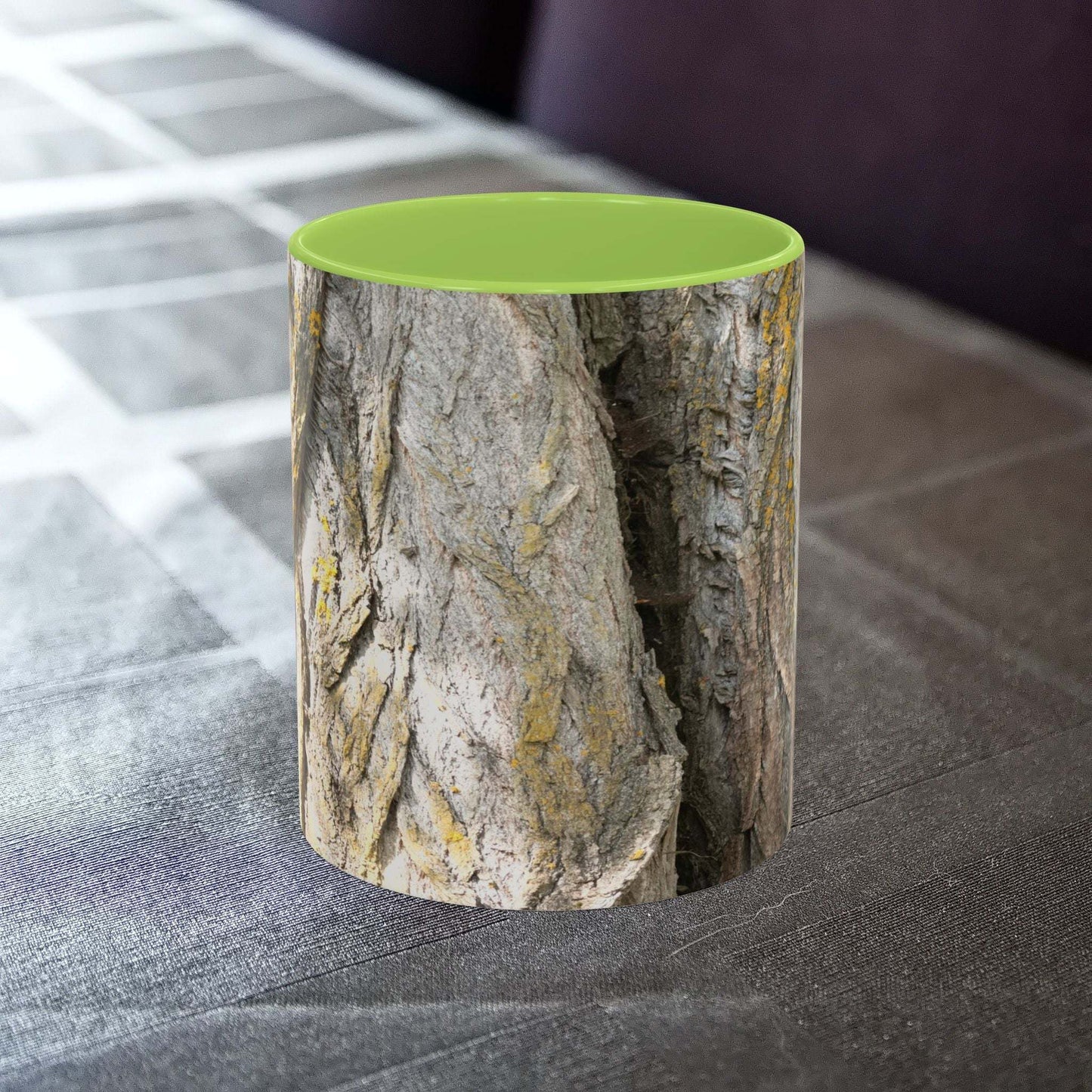 Coffee mug with tree trunk design on a table, showcasing a rustic and nature-themed aesthetic.