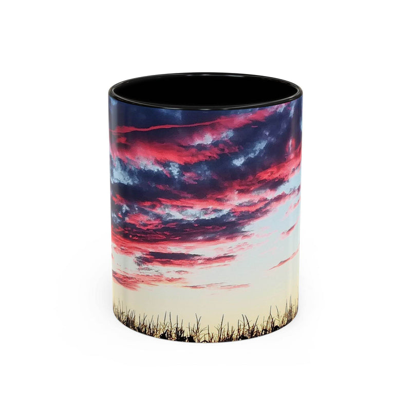 Artistic 11oz Sunset Accent Coffee Mug with a black handle and black inside on a rustic wood surface.