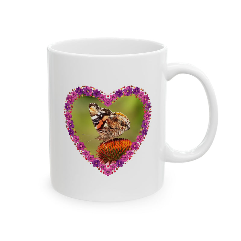 Floral 11oz Heart Flower Frame Butterfly Ceramic Mug standing next to a fresh green houseplant in a sunlit room.