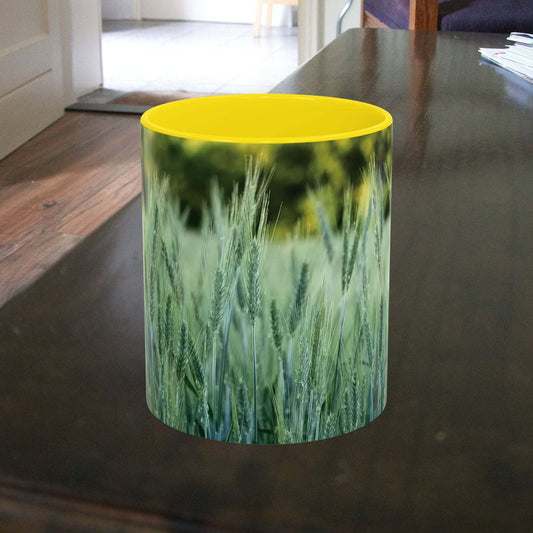 Wheat field design coffee mug on table.